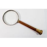 An old magnifying glass with wooden handle