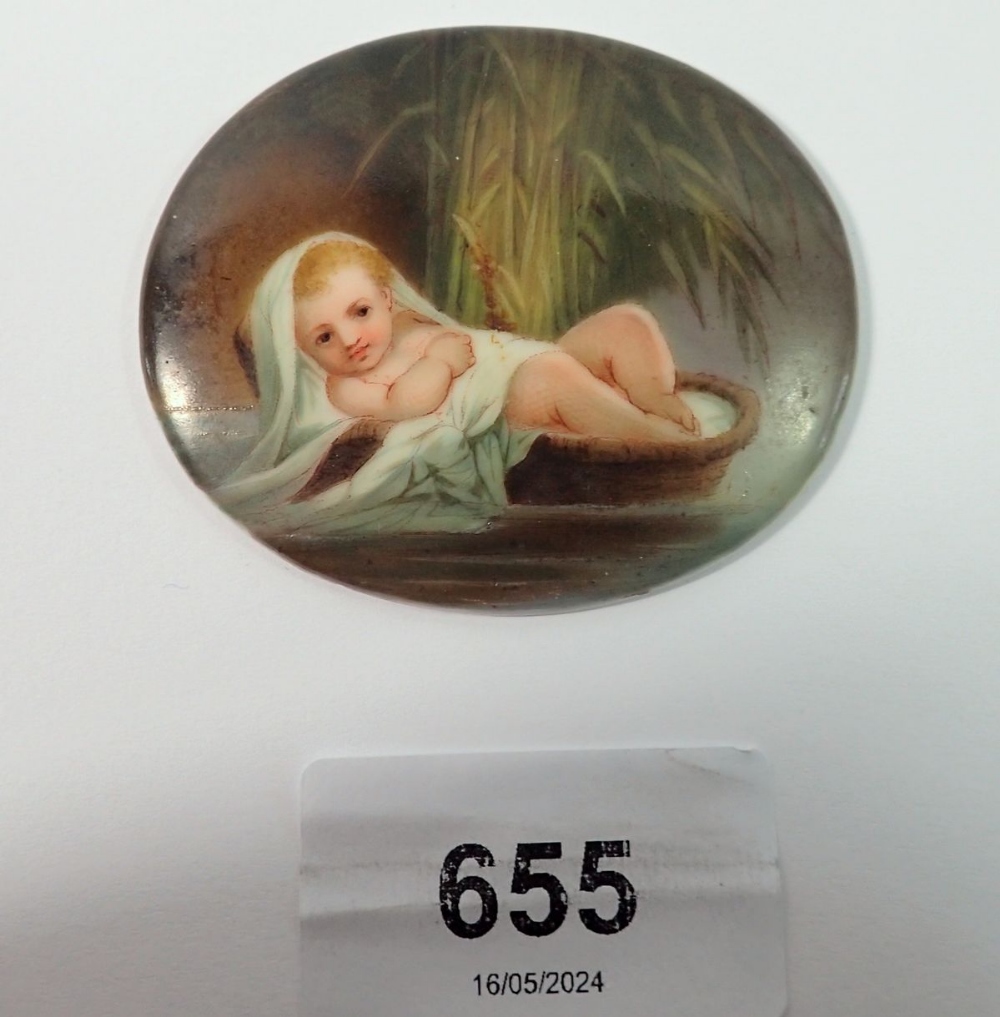 A 19th century porcelain miniature plaque painted baby Moses in a basket, 6 x 5cm