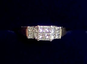 An 18 carat gold ring set three panels of four diamonds, size I, 3.6g