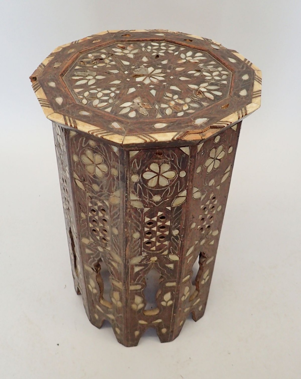 A Moroccan hardwood occasional table inlaid mother of pearl, 50cm tall, 32cm diameter