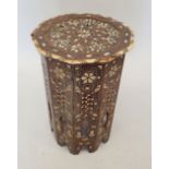 A Moroccan hardwood occasional table inlaid mother of pearl, 50cm tall, 32cm diameter