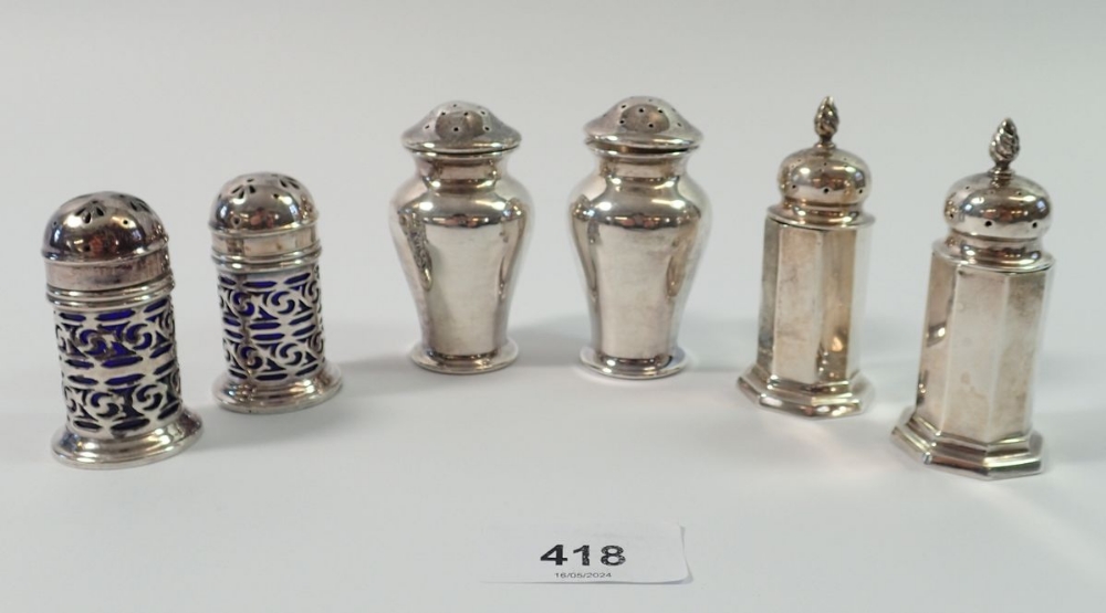 Two pairs of silver pepper pots, Birmingham 1897 and 1906 and a silver plated pair by Mappin & Webb