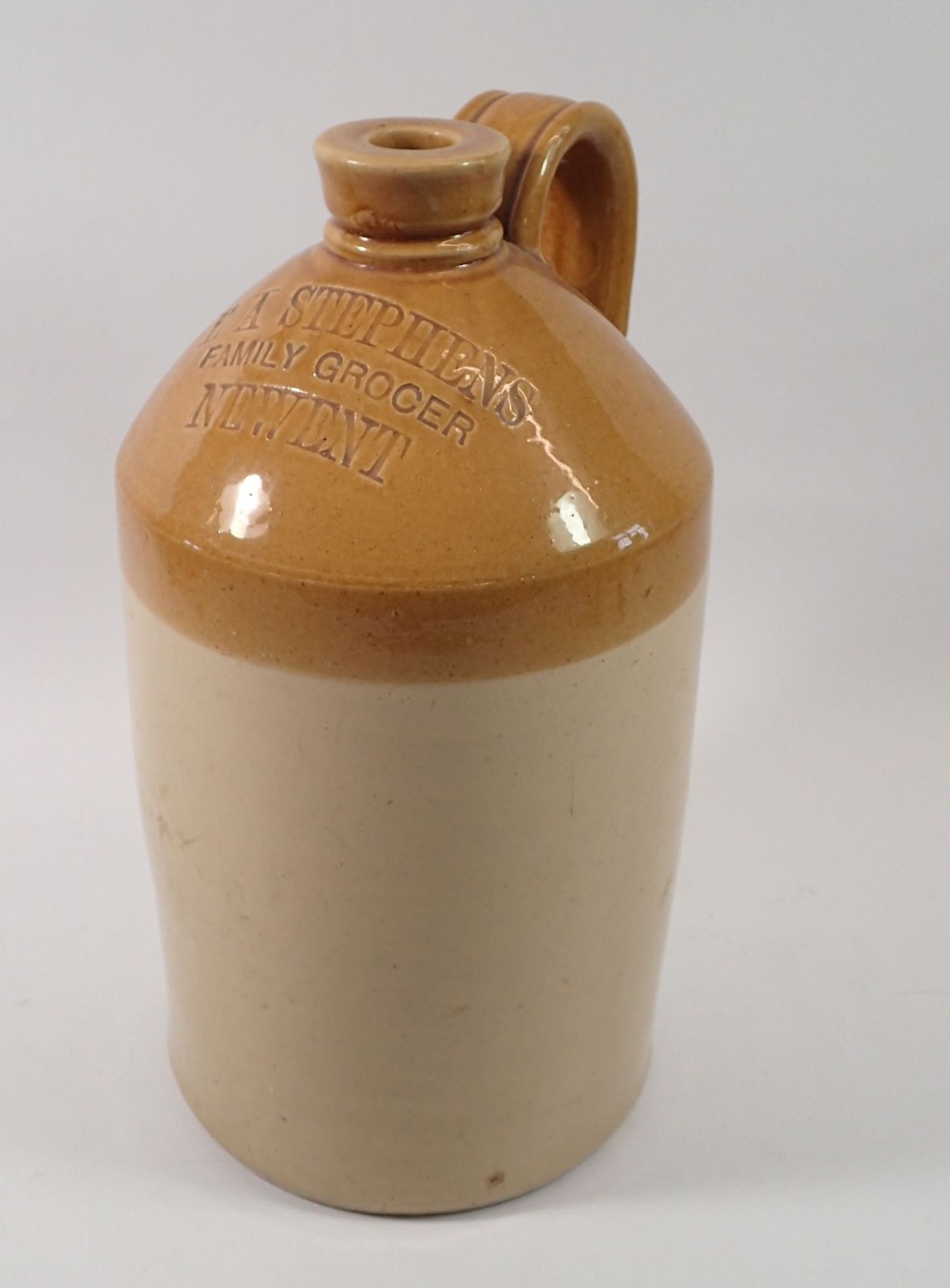 A stoneware flagon for E A Stephens family Grocer, Newent