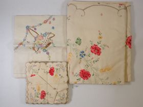 A vintage floral embroidered table cloth and matching napkins and other table linen