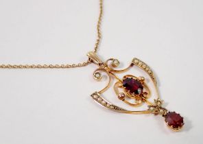 An Edwardian Art Nouveau openwork pendant set garnets and seed pearls, 4cm drop on 9 carat gold