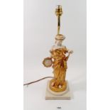 A simulated marble and gilt porcelain table lamp in the form of a maiden with tambourine, 45cm