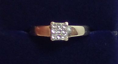 An 18 carat white gold ring set square panel of nine diamonds, size K, 3.1g