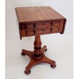 A 19th century mahogany work table with drop flaps and two drawers all on turned column with