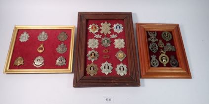 A framed display of eleven Royal Scots military cap badges etc with two other framed displays of