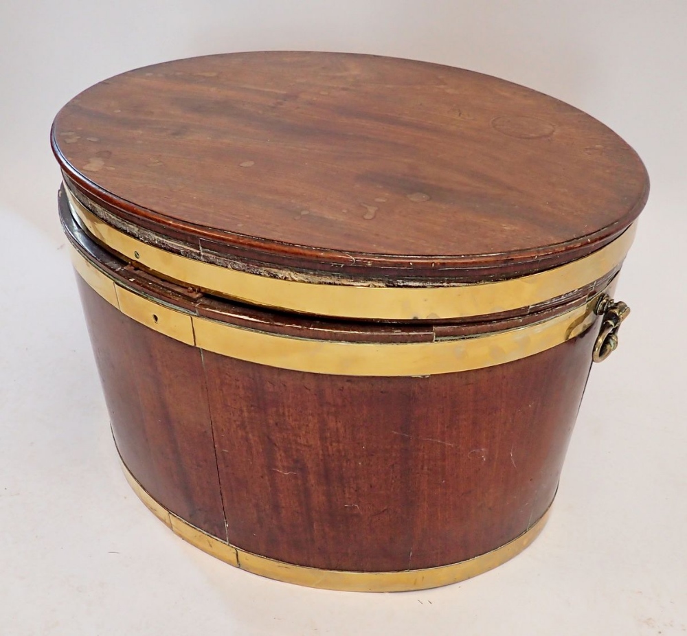 A George III mahogany oval brass bound wine cooler with hinged lid with later fitted lift out tray