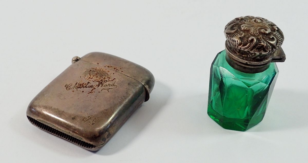 A silver topped green cut glass smelling salts bottle plus a silver vesta case engraved 'Charlie