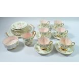 A Royal Albert Braemer tea service comprising six cups and seven saucers, nine tea plates, cake