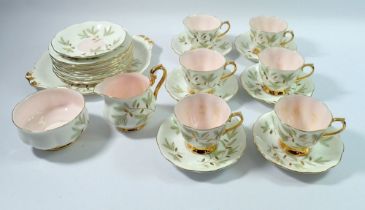 A Royal Albert Braemer tea service comprising six cups and seven saucers, nine tea plates, cake