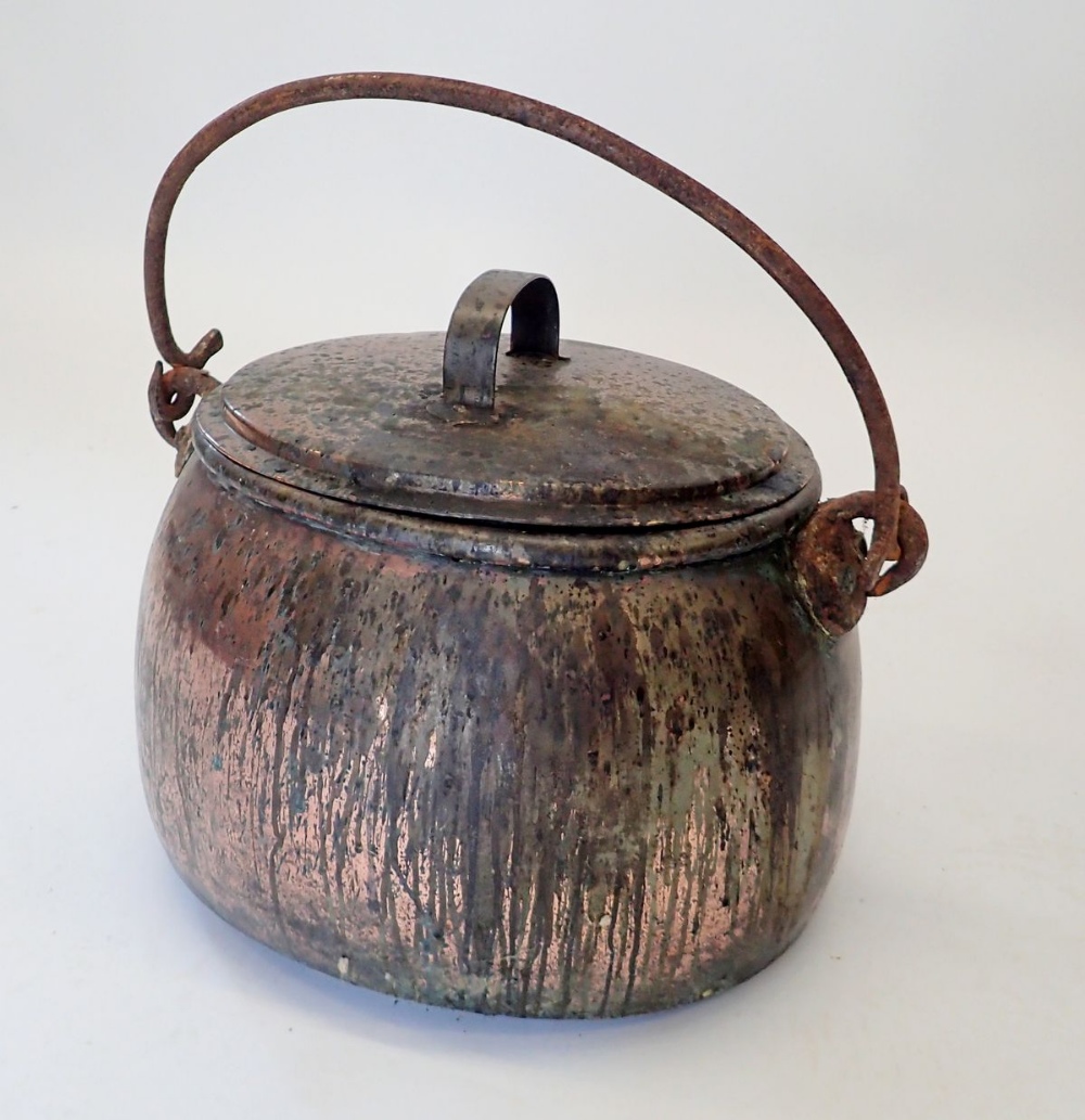 A Victorian large oval cooking pot with lid and hinged iron handle, 47cm wide