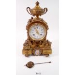 A 19th century French small gilt bronze mantel clock with Serves style porcelain panels and white