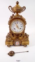 A 19th century French small gilt bronze mantel clock with Serves style porcelain panels and white