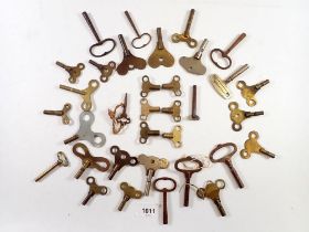 A collection of over 30 brass and other clock keys