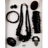 A collection of Victorian Whitby jet jewellery including brooches and necklace