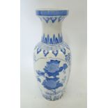 A large blue and white Chinese baluster urn form vase decorated flowers, 62cm tall
