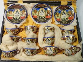 A Japanese eggshell tea set comprising twelve small cups and saucers, in fitted case (one cup a/f)