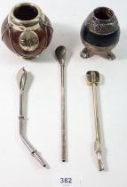Two white metal mounted nut form cups and three straws