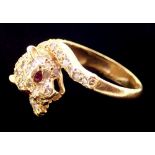 An 18 carat gold diamond set ring in the form of a leopard, with ruby eyes, size K, 5.5g