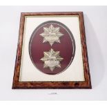 A framed display of two Hertfordshire Rifle Volunteer helmet plates