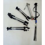 A group of six camera tripods