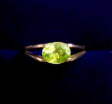 A 9 carat gold peridot ring on split shank, size M, 2.7g