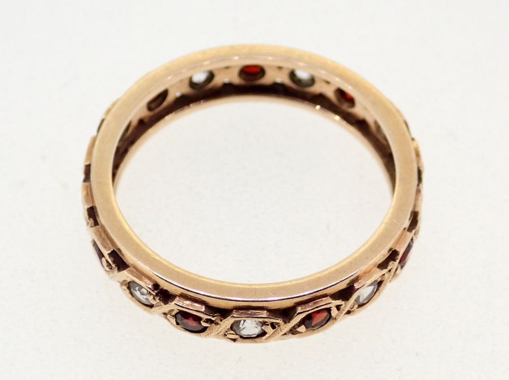 A 9 carat gold garnet and white stone eternity ring, size J to K, 2.2g - Image 3 of 3