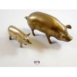 Two brass pigs, largest 18cm