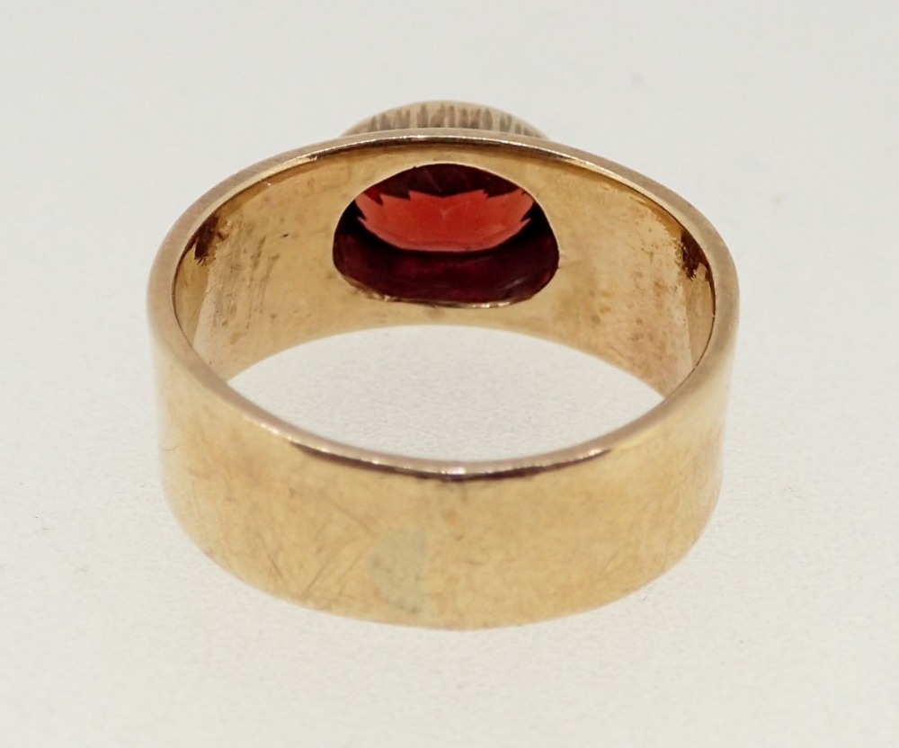 A 9 carat gold ring rub over set oval garnet on wide band and beaded shoulders, size L, 5.3g - Image 4 of 4