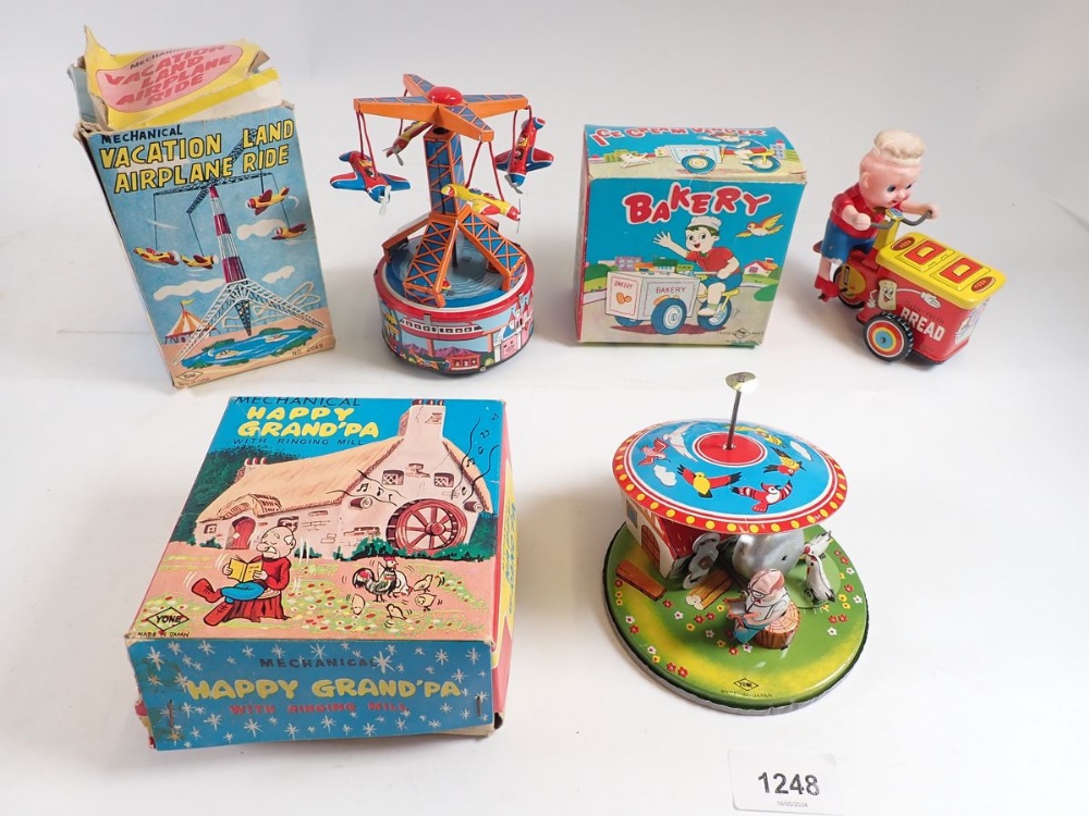 Three Japanese mechanical tin plate toys - 'Vacationland Airplane rRde' and 'Happy Grandpa with