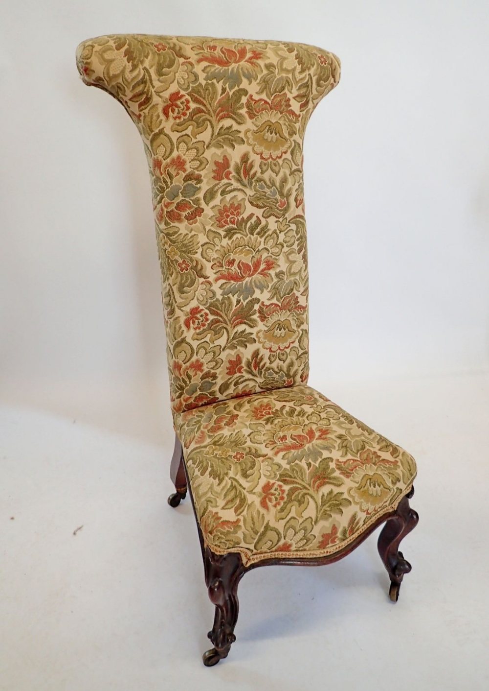 A Victorian pine dieu chair on carved scroll feet and castors