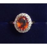 An 18 ct gold orange citrine and diamond cluster ring, 4.8g size M