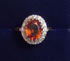 An 18 ct gold orange citrine and diamond cluster ring, 4.8g size M