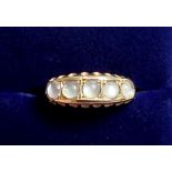 An 18 carat gold ring set five moonstones, size 0, 3g