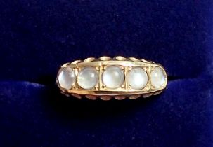 An 18 carat gold ring set five moonstones, size 0, 3g