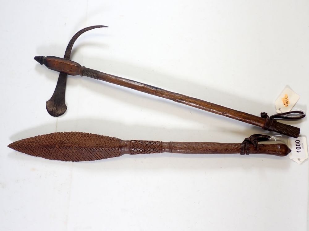 A short ceremonial war axe, 48cm and a carved paddle club, 49cm