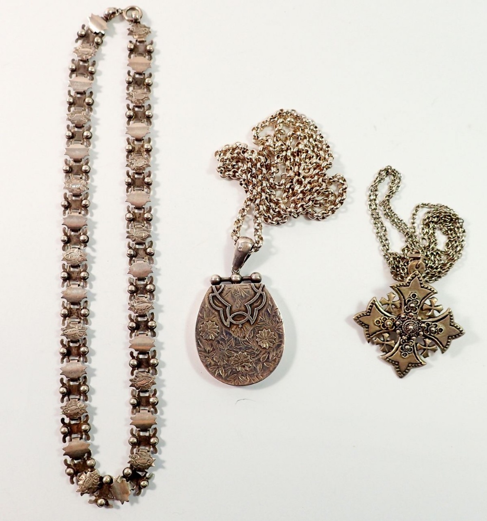 A large Victorian silver locket decorated flowers on a silver chain, 50g, a silver Jewish cross
