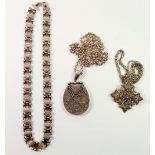 A large Victorian silver locket decorated flowers on a silver chain, 50g, a silver Jewish cross