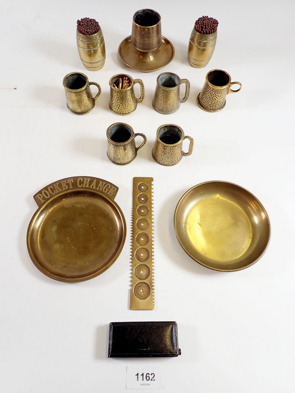 Various brass collectables including a Martin brass watch mainspring gauge, a brass match striker,