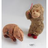 An early 20th century automaton toy monkey combing his hair and a clockwork bear - both reputed to