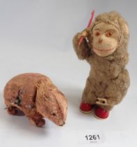 An early 20th century automaton toy monkey combing his hair and a clockwork bear - both reputed to