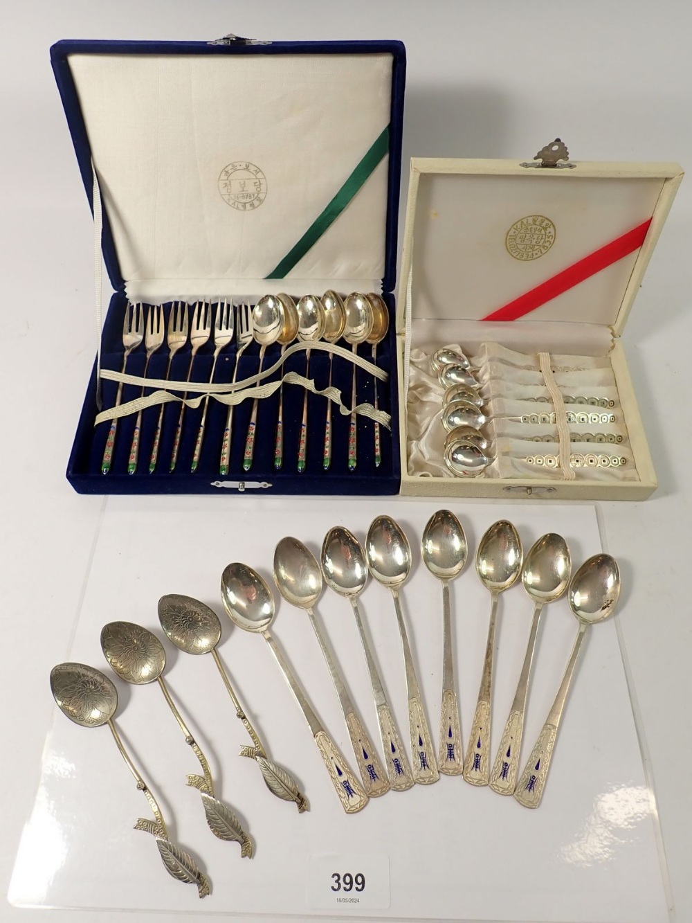 A set of six white metal oriental cocktail spoons and forks with enamel decoration plus variou