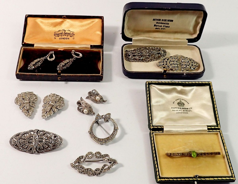 A group of vintage marcasite and paste brooches including one circular silver brooch, SJD earrings