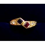 An 18 carat gold modern crossover ring set sapphire, ruby and four diamonds, size O, 3.2g