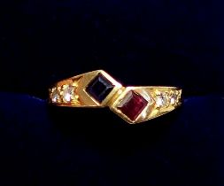 An 18 carat gold modern crossover ring set sapphire, ruby and four diamonds, size O, 3.2g