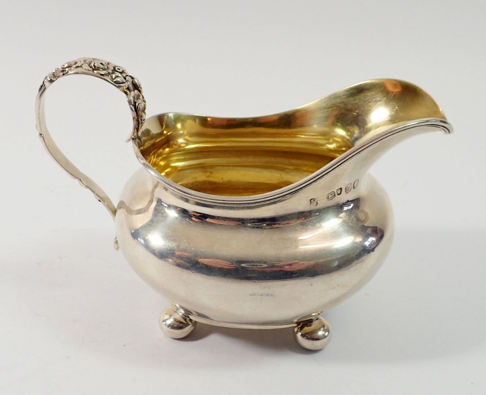 A Victorian silver milk jug with cast floral handle, London 1851, by Samuel Hayne & Dudley Cater,