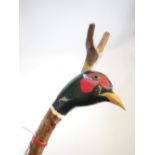 Two walking staffs - once carved and painted head of a pheasant with glass eyes 130cm and the